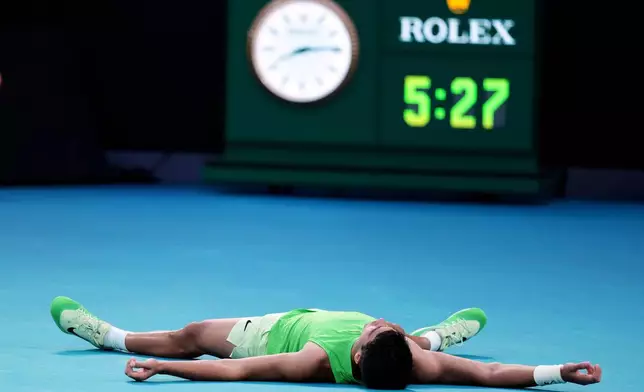 Carlos Alcaraz of Spain celebrates after defeating Alexander Zverev of Germany in their semifinal match at the Australian Open tennis championship in Melbourne, Australia, Friday, Jan. 30, 2026. (AP Photo/Asanka Brendon Ratnayake)