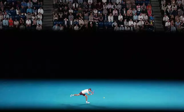 Alex de Minaur of Australia plays a backhand return to Hamad Medjedovic of Serbia during their second round match at the Australian Open tennis championship in Melbourne, Australia, Wednesday, Jan. 21, 2026. (AP Photo/Dita Alangkara)