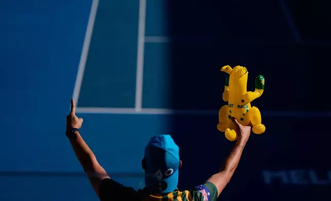 A supporter of Dane Sweeny of Australia reacts during his first round match against Gael Monfils of France at the Australian Open tennis championship in Melbourne, Australia, Tuesday, Jan. 20, 2026. (AP Photo/Asanka Brendon Ratnayake)