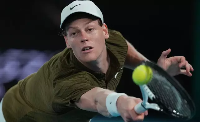 Jannik Sinner of Italy plays a backhand return to Novak Djokovic of Serbia during their semifinal match at the Australian Open tennis championship in Melbourne, Australia, early Saturday, Jan. 31, 2026. (AP Photo/Asanka Brendon Ratnayake)