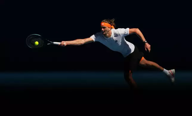 Alexander Zverev of Germany plays a forehand return to Gabriel Diallo of Canada during their first round match at the Australian Open tennis championship in Melbourne, Australia, Sunday, Jan. 18, 2026. (AP Photo/Dita Alangkara)