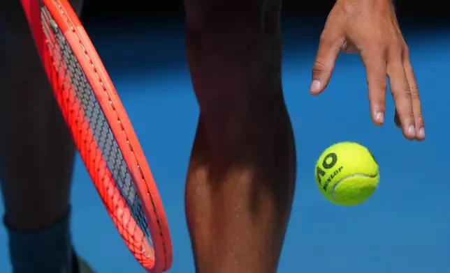 Flavio Cobolli of Italy prepares to serve to Arthur Fery of Britain during their first round match at the Australian Open tennis championship in Melbourne, Australia, Sunday, Jan. 18, 2026. (AP Photo/Aaron Favila)