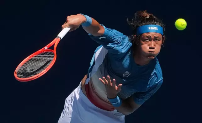 Zhang Zhizhen of China serves to Francisco Cerundolo of Argentina during their first round match at the Australian Open tennis championship in Melbourne, Australia, Sunday, Jan. 18, 2026. (AP Photo/Asanka Brendon Ratnayake)