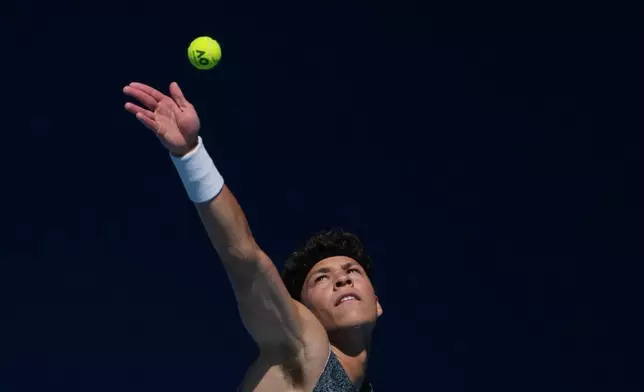 Ben Shelton of the U.S. serves to Ugo Humbert of France during their first round match at the Australian Open tennis championship in Melbourne, Australia, Tuesday, Jan. 20, 2026. (AP Photo/Asanka Brendon Ratnayake)