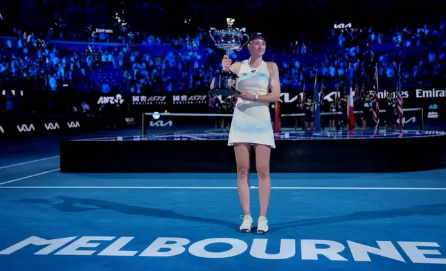 Elena Rybakina of Kazakhstan poses with the Daphne Akhurst Memorial Cup after defeating Aryna Sabalenka of Belarus to win the women's singles final at the Australian Open tennis championship in Melbourne, Australia, Saturday, Jan. 31, 2026. (AP Photo/Dita Alangkara)