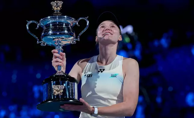 Elena Rybakina of Kazakhstan holds the Daphne Akhurst Memorial Cup after defeating Aryna Sabalenka of Belarus to win the women's singles final at the Australian Open tennis championship in Melbourne, Australia, Saturday, Jan. 31, 2026. (AP Photo/Dita Alangkara)
