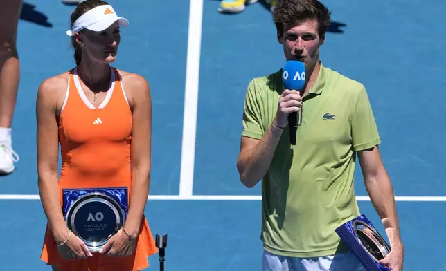 France's Kristina Mladenovic and Manuel Guinard address the crowd aftre losing to Australia's Olivia Gadecki and John Peers in the mixed doubles final at the Australian Open tennis championship in Melbourne, Australia, Friday, Jan. 30, 2026. (AP Photo/Aaron Favila)