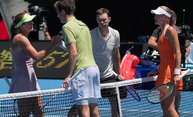 Australia's Olivia Gadecki, left, and John Peers, second right, are congratulated by France's Kristina Mladenovic, right, and Manuel Guinard, second left, after winning the mixed doubles final at the Australian Open tennis championship in Melbourne, Australia, Friday, Jan. 30, 2026. (AP Photo/Dita Alangkara)