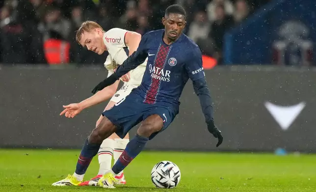 PSG's Ousmane Dembele, right, challenges for the ball with Lille's Hakon Arnar Haraldsson during the French League One soccer match between Paris Saint-Germain and Lille in Paris, France, Friday, Jan. 16, 2026. (AP Photo/Michel Euler)