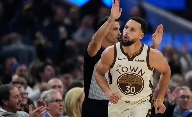 Golden State Warriors guard Stephen Curry (30) reacts after making a 3-point basket during the first half of an NBA basketball game against the Sacramento Kings, Friday, Jan. 9, 2026, in San Francisco. (AP Photo/Godofredo A. Vásquez)
