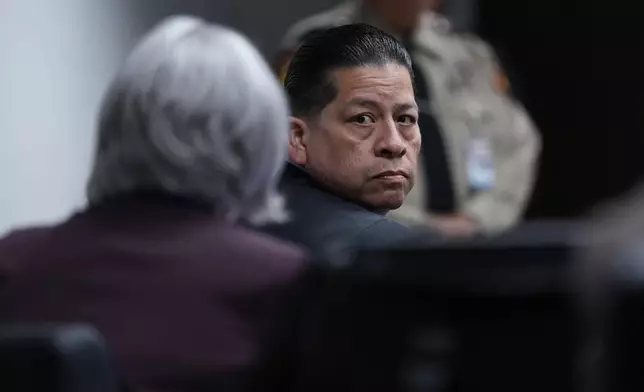 Former Uvalde school district police officer Adrian Gonzales looks back while seated in the courtroom at the Nueces County Courthouse in Corpus Christi, Texas, Tuesday, Jan. 6, 2026. (AP Photo/Eric Gay, Pool)