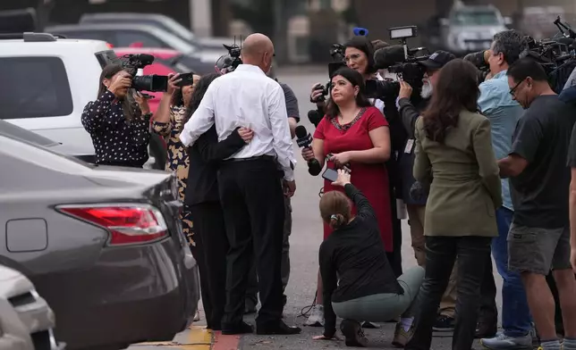 Family member Jesse Rizo, center, talks to the media before the trial for former Uvalde school district police officer Adrian Gonzales at the Nueces County Courthouse in Corpus Christi, Texas, Tuesday, Jan. 6, 2026. (AP Photo/Eric Gay)