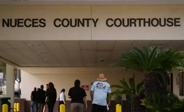 People enter the Nueces County Courthouse in Corpus Christi, Texas, as jury selection continues in the trial for former Uvalde school district police officer Adrian Gonzales, Monday, Jan. 5, 2026. (AP Photo/Eric Gay)