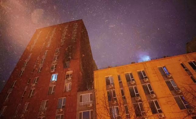 A residential building is seen damaged by a Russian strike on Kyiv, Ukraine, on Friday, Jan. 9, 2026. (AP Photo/Evgeniy Maloletka)