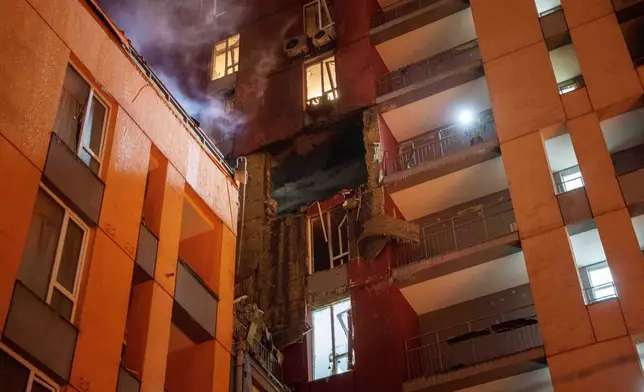 Smoke rises from a residential building damaged by a Russian strike on Kyiv, Ukraine, on Friday, Jan. 9, 2026. (AP Photo/Evgeniy Maloletka)
