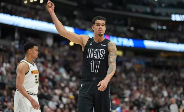 Brooklyn Nets forward Michael Porter Jr. gestures to the bench in the first half of an NBA basketball game against the Denver Nuggets, Thursday, Jan. 29, 2026, in Denver. (AP Photo/David Zalubowski)
