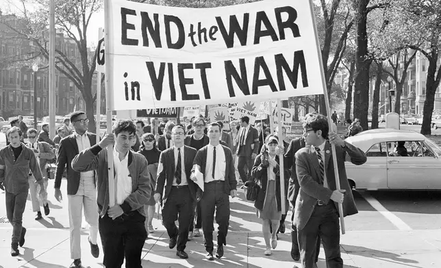 FILE - College students from various nearby schools march down Commonwealth Avenue in Boston on Oct. 16, 1965 to attend rally on Boston Common protesting U.S. involvement in Vietnam. (AP Photo/Frank C. Curtin, File)