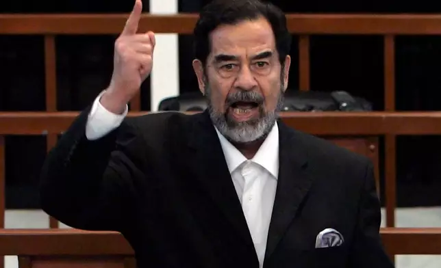 FILE - Former Iraqi president Saddam Hussein yells at the court as the verdict is delivered during his trial held under tight security in Baghdad's heavily fortified Green Zone, Sunday Nov. 5, 2006. (AP Photo/David Furst, Pool, File)