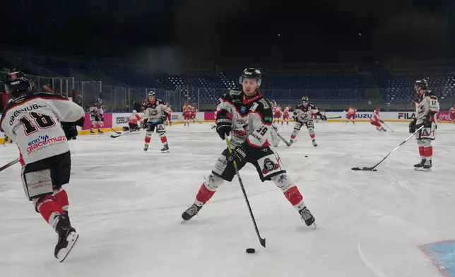Wipptal Broncos players warm up at the Santa Giulia Ice Hockey Arena, in Milan, where Ice Hockey discipline of the Milan Cortina 2026 Winter Olympics will take place, in Milan, Italy, Sunday, Jan. 11, 2026. (AP Photo/Luca Bruno)