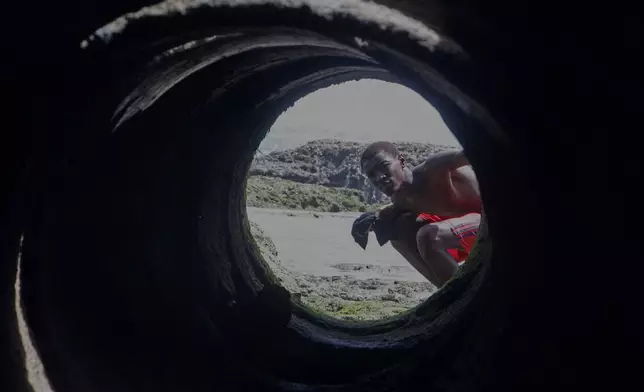 A man looks into a tunnel at the port in Mogadishu, Somalia, Thursday, Jan. 8, 2026. (AP Photo/Farah Abdi Warsameh)