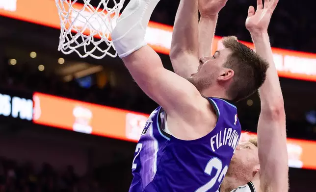 Utah Jazz center Kyle Filipowski, left, goes up to shoot over Brooklyn Nets forward Danny Wolf (2) during the second half of an NBA basketball game, Friday, Jan. 30, 2026, in Salt Lake City. (AP Photo/Anna Fuder)