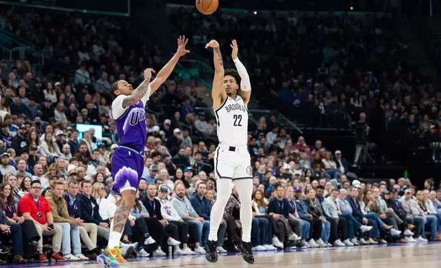 Brooklyn Nets forward Jalen Wilson (22) shoots over Utah Jazz guard Keyonte George, left, during the first half of an NBA basketball game, Friday, Jan. 30, 2026, in Salt Lake City. (AP Photo/Anna Fuder)