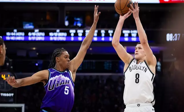 Brooklyn Nets guard Egor Dëmin (8) looks to shoot over Utah Jazz forward Cody Williams (5) during the first half of an NBA basketball game, Friday, Jan. 30, 2026, in Salt Lake City. (AP Photo/Anna Fuder)