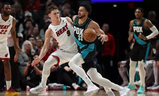Portland Trail Blazers forward Toumani Camara (33) drives to the basket as Miami Heat guard Pelle Larsson (9) defends during the first half of an NBA basketball game Thursday, Jan. 22, 2026, in Portland, Ore. (AP Photo/Amanda Loman)