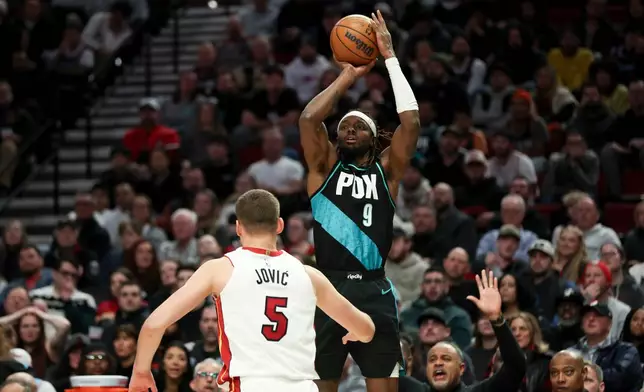 Portland Trail Blazers forward Jerami Grant (9) shoots over Miami Heat forward Nikola Jovic (5) during the second half of an NBA basketball game Thursday, Jan. 22, 2026, in Portland, Ore. (AP Photo/Amanda Loman)