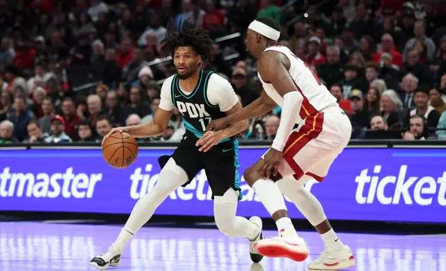 Portland Trail Blazers guard Shaedon Sharpe (17) drives to the basket as Miami Heat center Bam Adebayo (13) defends during the second half of an NBA basketball game Thursday, Jan. 22, 2026, in Portland, Ore. (AP Photo/Amanda Loman)