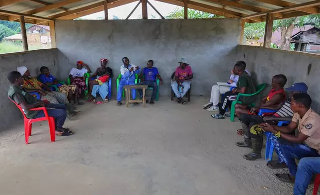 Residents express their disappointment with the failure of Bea Mountain Mining Corporation to deliver promises such as schools, hospitals and employment, July 11, 2025, in Gbargbo, Liberia. (AP Photo/Misper Apawu)