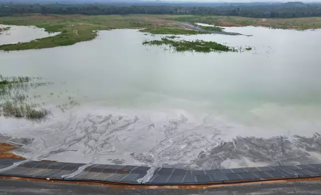 An aerial view shows mining waste flowing into a large pond at an inland location east of Grand Cape Mount, not far from the Mano River in Liberia, July 9, 2025. (AP Photo/Misper Apawu)