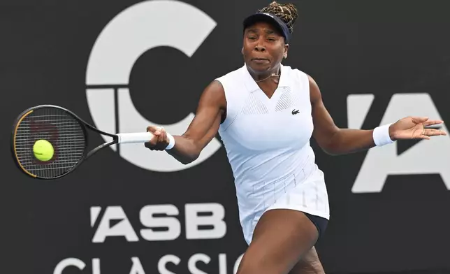 Venus Williams of the U.S. hits a forehand to Magda Linette of Poland during her singles match at the ASB Classic Women's Tennis Tournament in Auckland, New Zealand, Tuesday Jan. 6, 2026. (Andrew Cornaga/Photosport via AP)