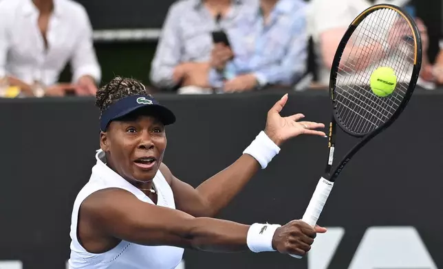 Venus Williams of the U.S. hits a backhand to Magda Linette of Poland during her singles match of the ASB Classic Women's Tennis Tournament in Auckland, New Zealand, Tuesday Jan. 6, 2026. (Andrew Cornaga/Photosport via AP)