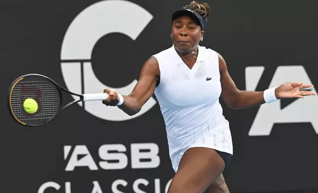 Venus Williams of the U.S. hits a forehand to Magda Linette of Poland during her singles match at the ASB Classic Women's Tennis Tournament in Auckland, New Zealand, Tuesday Jan. 6, 2026. (Andrew Cornaga/Photosport via AP)