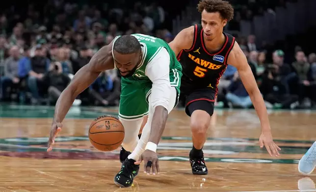 Boston Celtics guard Jaylen Brown loses possession of the ball wile being guarded by Atlanta Hawks guard Dyson Daniels (5) during the first half of an NBA basketball game, Wednesday, Jan. 28, 2026, in Boston. (AP Photo/Robert F. Bukaty)