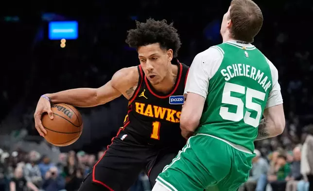 Atlanta Hawks forward Jalen Johnson (1) fouls Boston Celtics guard Baylor Scheierman (55) during the second half of an NBA basketball game, Wednesday, Jan. 28, 2026, in Boston. (AP Photo/Robert F. Bukaty)