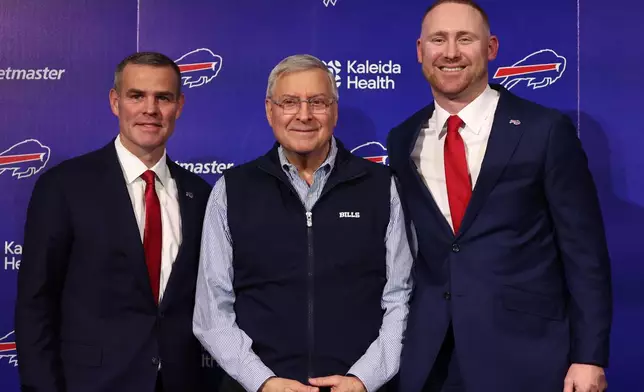 Joe Brady, right, poses for a photo after being introduced as the new head coach of the Buffalo Bills by general manager Brandon Beane, left, and Owner Terry Pegula, center, in Orchard Park, N.Y., Thursday, Jan. 29, 2026. (AP Photo/Jeffrey T. Barnes)