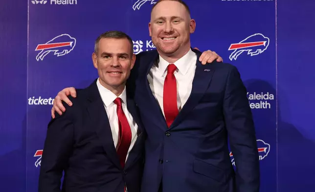 Joe Brady, right, poses for a photo after being introduced as the new head coach of the Buffalo Bills by general manager Brandon Beane, left, in Orchard Park, N.Y., Thursday, Jan. 29, 2026. (AP Photo/Jeffrey T. Barnes)