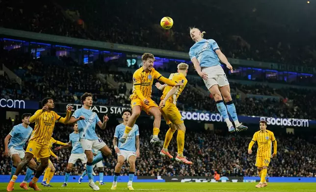 Manchester City's Erling Haaland attempts a head at goal during the English Premier League soccer match between Manchester City and Brighton and Hove Albion in Manchester, England, Wednesday, Jan. 7, 2026. (AP Photo/Dave Thompson)