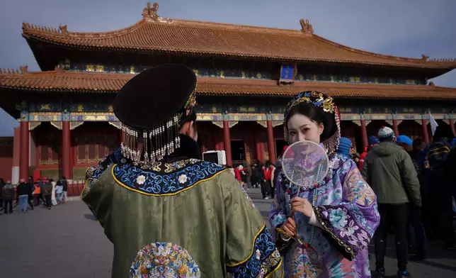 Chinese girls dressed in Qing Dynasty attire at the Forbidden City in Beijing, China, Wednesday, Jan. 7, 2026. (AP Photo/Vincent Thian)