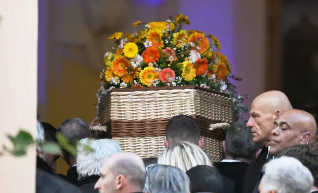 Actor Brigitte Bardot's coffin is carried into Notre-Dame de l'Assomption church for her funeral ceremony, Wednesday, Jan. 7, 2026 in Saint-Tropez, southern France. (AP Photo/Philippe Magoni)