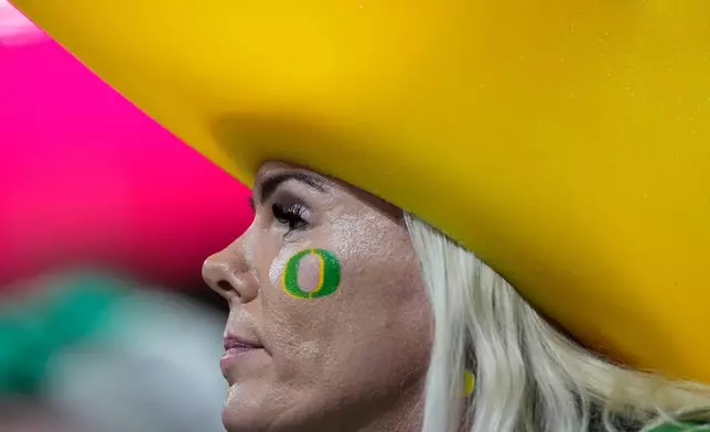 An Oregon fan watches during the second half of the Peach Bowl NCAA college football playoff semifinal against Indiana, Friday, Jan. 9, 2026, in Atlanta. (AP Photo/Mike Stewart)