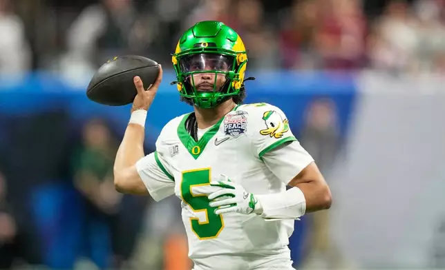 Oregon quarterback Dante Moore (5) passes against Indiana during the second half of the Peach Bowl NCAA college football playoff semifinal, Friday, Jan. 9, 2026, in Atlanta. (AP Photo/Brynn Anderson)