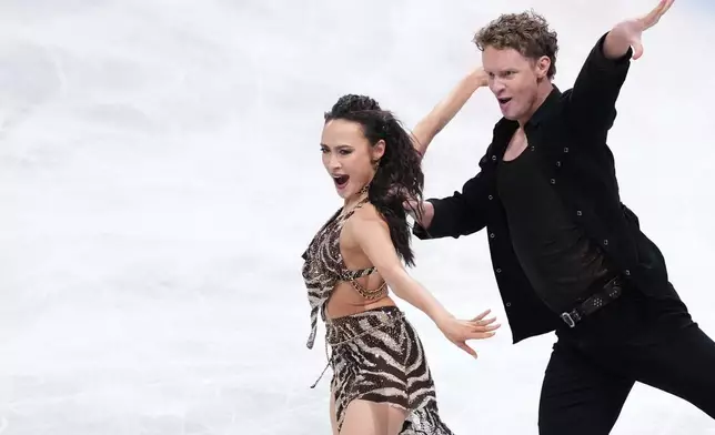FILE - Madison Chock and Evan Bates, of the United States, compete in the ice dance's rhythm dance segment at the ISU Grand Prix of Figure Skating Final in Nagoya, central Japan, Thursday, Dec. 4, 2025. (AP Photo/Hiro Komae, File)