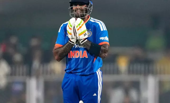 India's captain Suryakumar Yadav reacts as he celebrates after scoring fifty runs during the third T20 cricket match between India and New Zealand in Guwahati, India, Sunday, Jan. 25, 2026. (AP Photo/Anupam Nath)