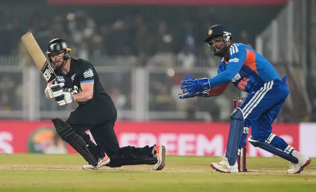 New Zealand's Glenn Phillips plays a shot during the third T20 cricket match between India and New Zealand in Guwahati, India, Sunday, Jan. 25, 2026. (AP Photo/Anupam Nath)