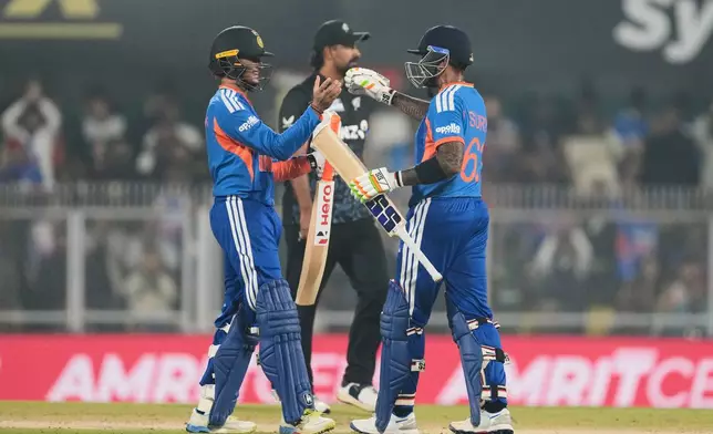 India's captain Suryakumar Yadav, right, greets India's Abhishek Sharma as he scores fifty run during the third T20 cricket match between India and New Zealand in Guwahati, India, Sunday, Jan. 25, 2026. (AP Photo/Anupam Nath)