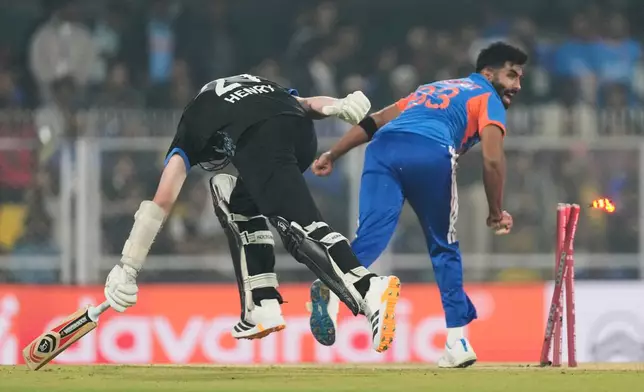 New Zealand's Matt Henry, left, run out by India's Jasprit Bumrah during the third T20 cricket match between India and New Zealand in Guwahati, India, Sunday, Jan. 25, 2026. (AP Photo/Anupam Nath)