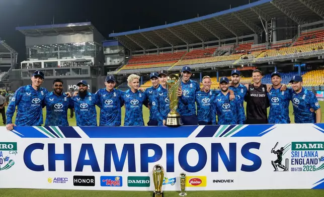 England's team members pose with the trophy following their win over Sri Lanka in the third ODI cricket match between England and Sri Lanka in Colombo, Sri Lanka, Tuesday, Jan. 27, 2026. (AP Photo/Eranga Jayawardena)